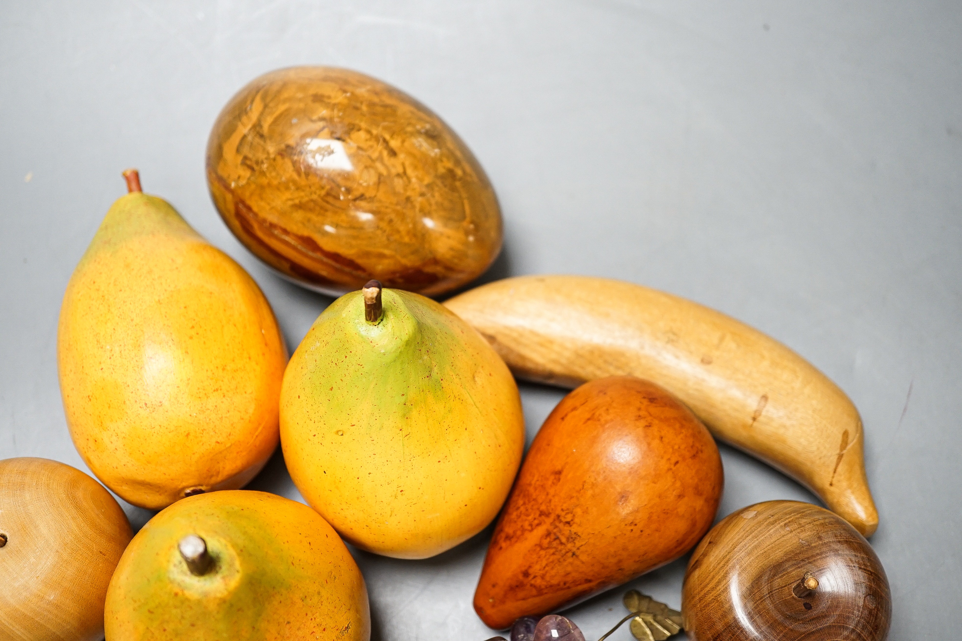 A group of polished stone and wood models of fruit, eggs, et.